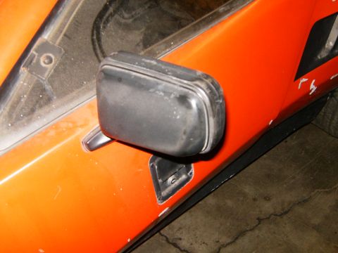 2000 Ford E350 - Side mirror detail on an orange vehicle.