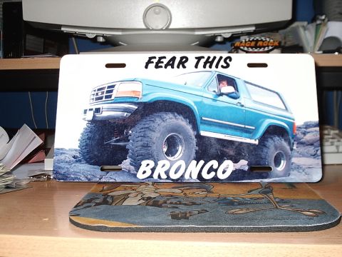 1996 Ford Bronco - License plate displays a lifted Ford Bronco with custom text and graphics.