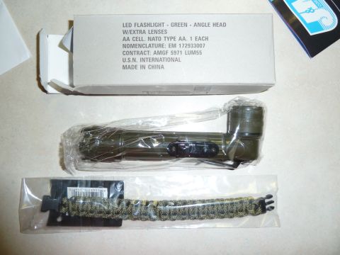 1992 Ford Mustang - A green LED flashlight with an angle head and extra lenses, along with a paracord bracelet, are displayed with their packaging.
