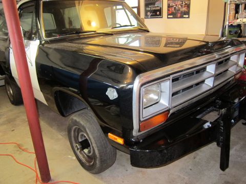 1987 Dodge 1500 - This Dodge 1500 pickup truck is parked indoors, showing its front end and driver's side.