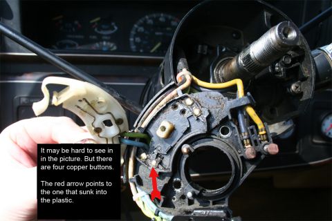 1987 Ford Bronco - Steering column switch assembly detail, showing copper buttons and wiring. The red arrow points to a sunk button.