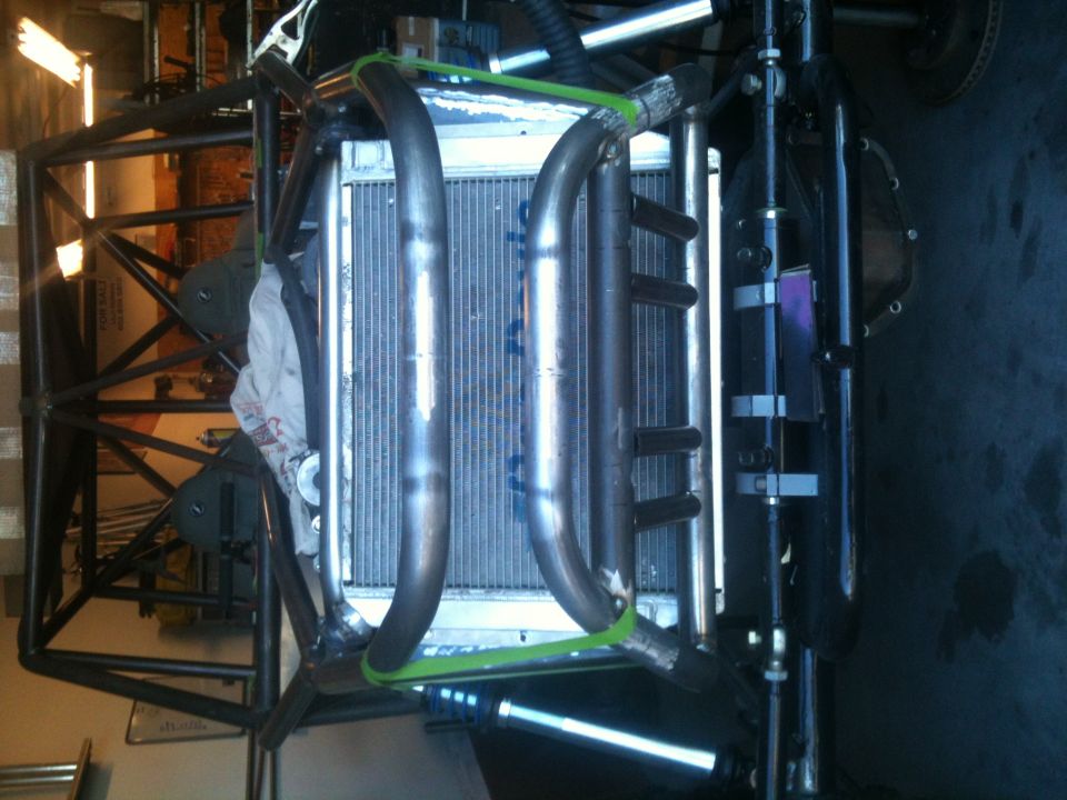 Off-road buggy chassis frame with radiator and exhaust pipes