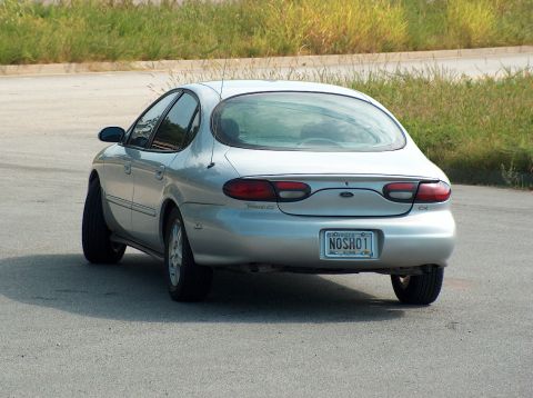 1998 Ford Taurus - This silver sedan is seen from the rear, with the license plate reading NOSHO1.