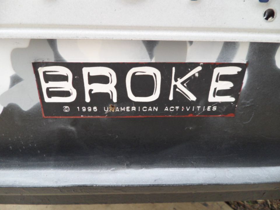Sticker that says BROKE and 1996 UNAMERICAN ACTIVITIES