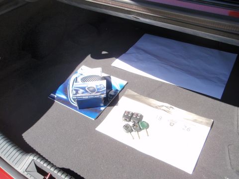 2000 Jaguar S-Type - Car keys and brochures are visible inside the trunk of a vehicle.