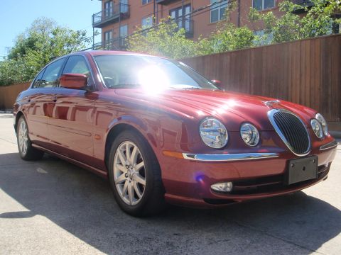 2000 Jaguar S-Type - 2000 Jaguar S-Type sedan in red, seen from the front three-quarter angle.