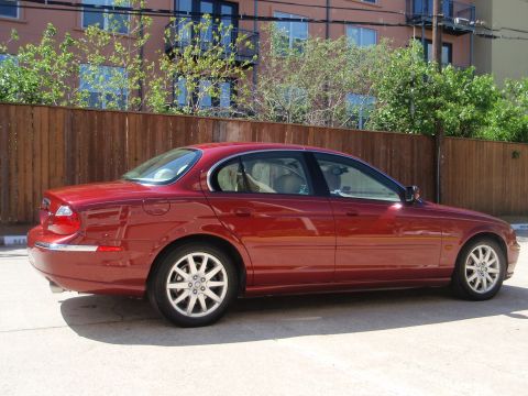 2000 Jaguar S-Type - This red 2000 Jaguar S-Type sedan is shown from the side.