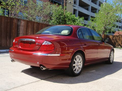 2000 Jaguar S-Type - Rear view of a red 2000 Jaguar S-Type sedan parked outdoors.