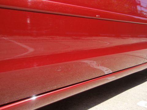 2000 Jaguar S-Type - Red car door panel detail, showing the lower body line and trim.