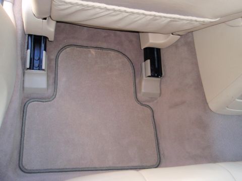 2000 Jaguar S-Type - Close-up of a car's interior floor mat, showing the carpet and seat mounting hardware.