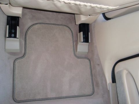 2000 Jaguar S-Type - Interior view of a car's floor mat and seat mounting hardware.