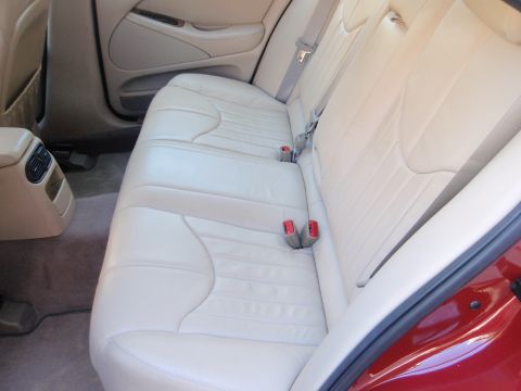 2000 Jaguar S-Type - The interior of a car shows cream-colored leather seats and door panels, with a visible watermark.