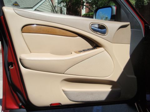 2000 Jaguar S-Type - Interior door panel of a 2000 Jaguar S-Type shows wood trim and leather details.