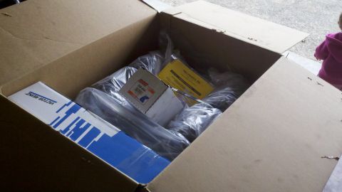 1978 Ford Bronco - Box of new car parts, possibly for a motor rebuild, with visible brand labels.