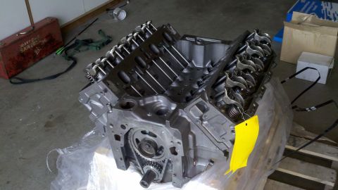 1978 Ford Bronco - Engine assembly, likely for a rebuild, sits on plastic wrap with a yellow tag and Supermotors logo visible.