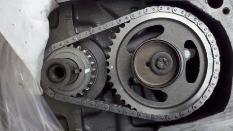 1978 Ford Bronco - Close-up of engine timing chain and gears, with a star-shaped bolt head visible on one gear.