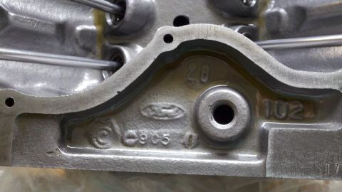1978 Ford Bronco - This image shows a close-up of a cast metal engine part with visible Ford branding and numerical markings.