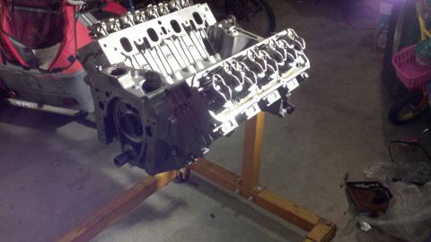 1978 Ford Bronco - Engine block and cylinder heads are visible, mounted on an engine stand in a garage setting.