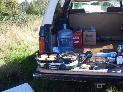 1985 Ford Bronco - Cooking breakfast outdoors from the back of a vehicle.