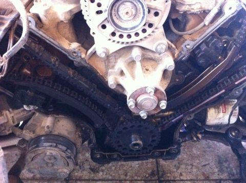 1998 Ford Crown Victoria - Close-up view of engine timing chains and water pump during replacement work.