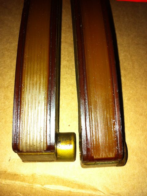 1998 Ford Crown Victoria - Close-up of two automotive timing chain guides, one showing a metal cylindrical attachment.