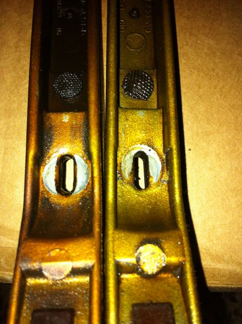 1998 Ford Crown Victoria - Comparison of two timing arms, one appearing older or worn, showing differences in finish and texture.