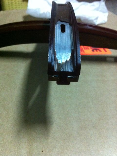 1998 Ford Crown Victoria - Close-up of a damaged metal component with blue residue inside a channel.