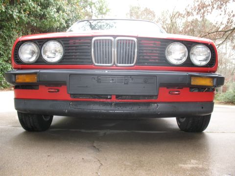 1986 BMW 3 Series - Front view of a red 1986 BMW 3 Series, its iconic grille and dual headlights.