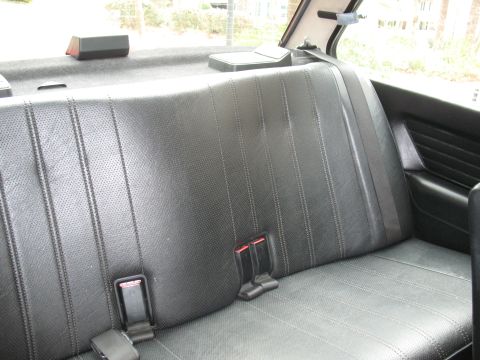 1986 BMW 3 Series - Interior view of a car's rear seat, showing the seat upholstery and seatbelts.