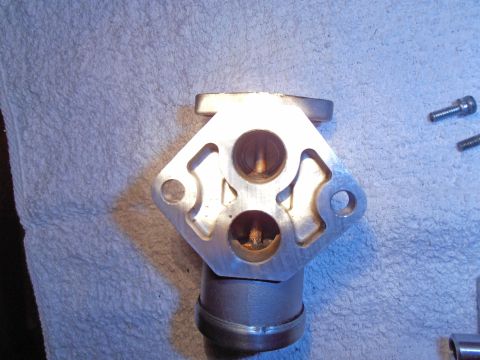 1990 Ford Bronco - Close-up view of a throttle body, a critical component in an engine's air intake system.