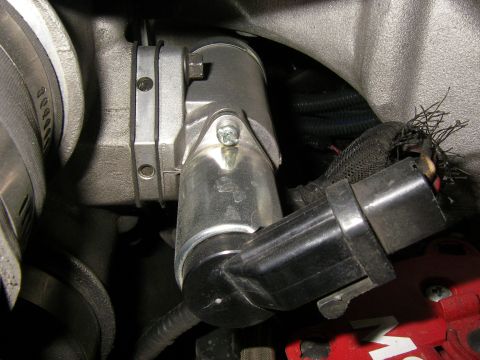 1990 Ford Bronco - A close-up view of a vehicle's idle air control valve and associated wiring harness.
