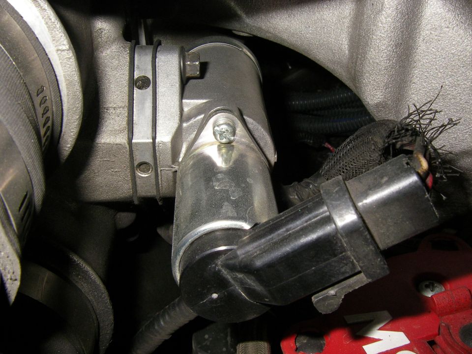 Close-up of an idle air control valve assembly with wiring