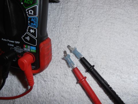 1990 Ford Bronco - Digital multimeter with test leads, ready for electrical measurements.