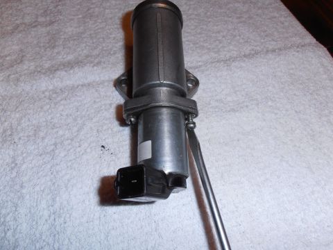 1990 Ford Bronco - An idle air control valve is shown with a screwdriver inserted into its side.