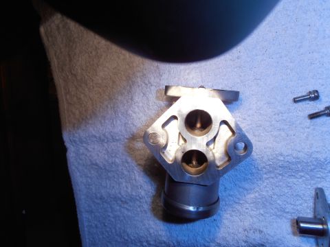 1990 Ford Bronco - A metal IAC valve is shown on a white towel with two screws nearby.