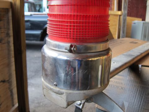 1991 Ford LTD Crown Victoria - A red warning light is mounted on a chrome base, with a dark vehicle in the background.