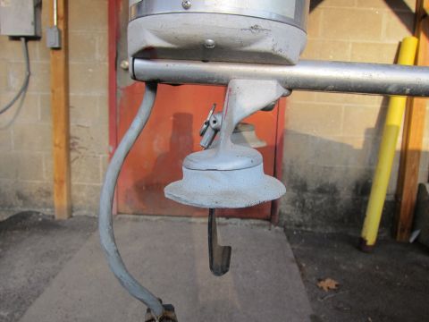 1991 Ford LTD Crown Victoria - Detail of an outboard motor's lower unit, showing the propeller shaft and mounting bracket.