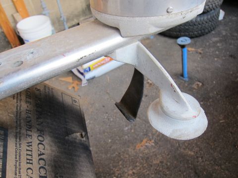 1991 Ford LTD Crown Victoria - Close-up of an outboard motor's lower unit, showing the propeller shaft and a fin.