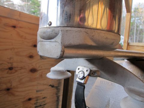 1991 Ford LTD Crown Victoria - Detail of an outboard motor part, showing a clamp and strap mechanism.