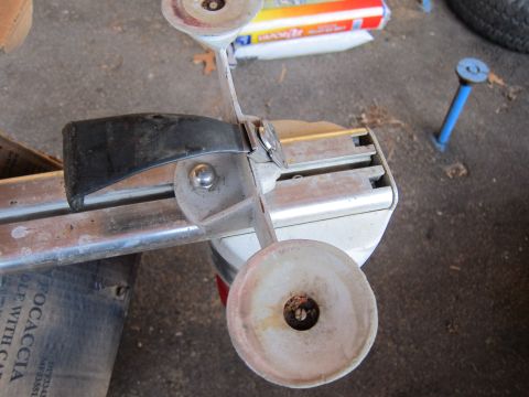 1991 Ford LTD Crown Victoria - Close-up of a grinding wheel assembly, with visible wear and tear on its components.
