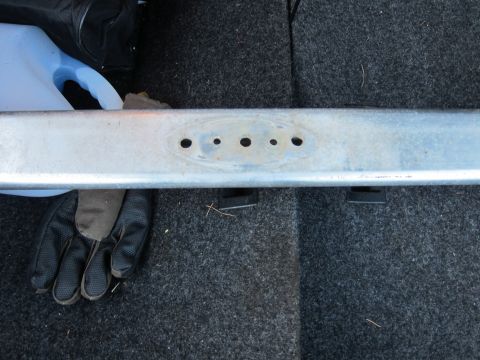 1991 Ford LTD Crown Victoria - A metal bar with multiple holes is shown, possibly a part from a vehicle or trailer.