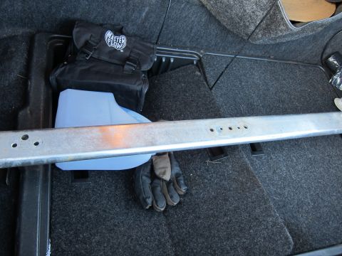 1991 Ford LTD Crown Victoria - Trunk interior contains a tool bag, fluid container, and gloves, not a 1991 Ford Crown Victoria LTD.
