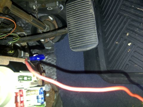 2000 Ford Crown Victoria - Close-up of a vehicle's interior, showing the fuse box and brake and gas pedals.