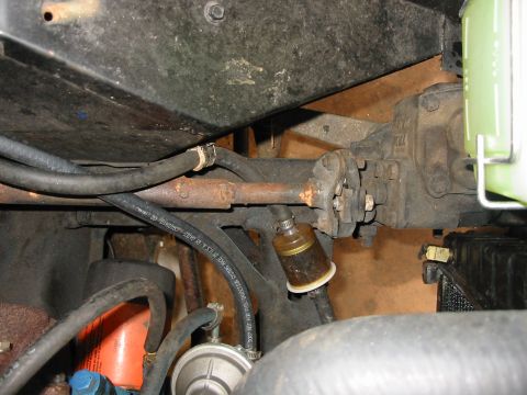 1969 Ford Bronco - Close-up of vehicle's power steering mechanism and fuel filter assembly.