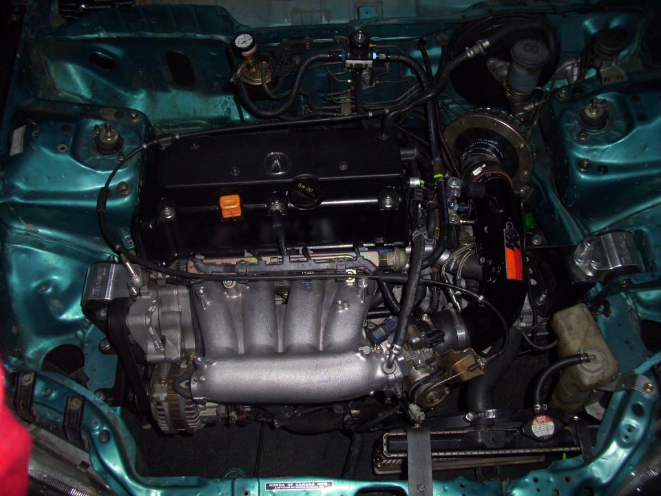 Engine bay with teal paint and black engine cover