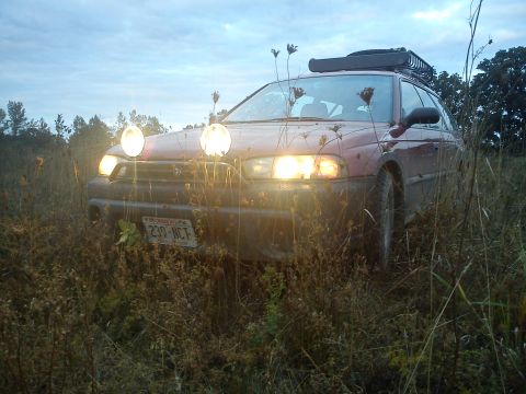 1998 Subaru Legacy - This lifted 1998 Subaru Outback is equipped with auxiliary lights and a roof rack, ready for off-road adventure.