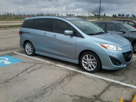 2012 Mazda Mazda 5 - Light blue 2012 Mazda Mazda 5 minivan parked in a handicapped spot.