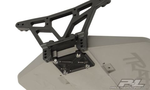 1986 Ford Bronco - RC car wing mount assembly with 'SUPERMOTORS' branding visible on the body.