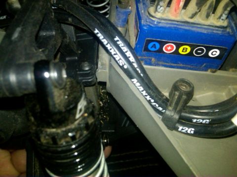 1986 Ford Bronco - This image shows internal components of a remote control vehicle, including an electronic speed controller and hoses.