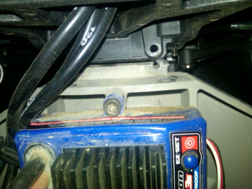 Blue electronic speed controller with black wires and a red button labeled EZ-SET